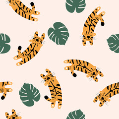 Vector seamless pattern with spotted tigers.  Tigers on a beige background are jumping into palm leaves.  Wildlife and fauna, Vector flat illustration.  A family of felines or carnivores.