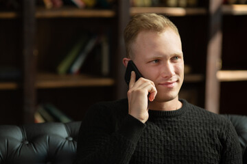 portrait of caucasian businessman talking on the phone in the office 