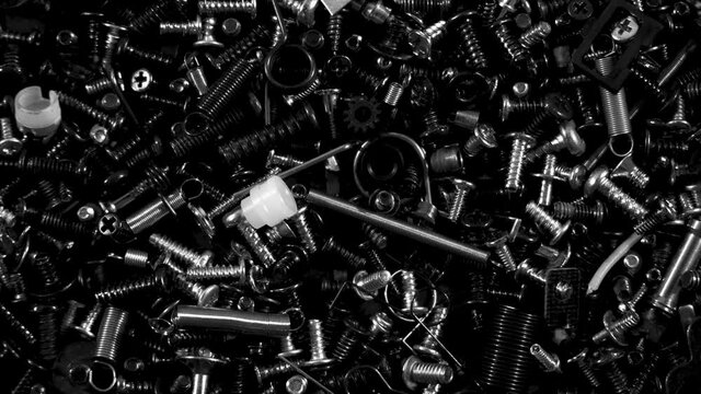Bolts and screw in motion with dramatic noir look