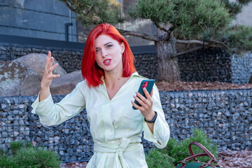Angry indignant business woman annoyed with a missed call or no signal on a stuck idle mobile phone. Angry frustrated girl holding mobile phone angry at bank