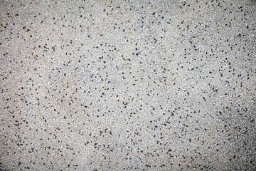 Cement mixed small gravel stone wall or floor texture background,The Dust Texture. Abstract dense splash texture. Random pebble gravel oval elements seamless pattern.