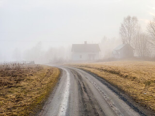 Abandoned houses on dirt road in rural sweden.