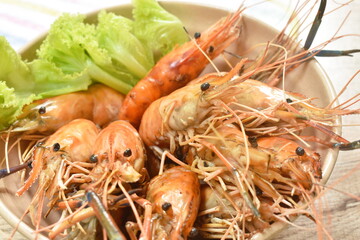 grilled river shrimp arranging with fresh lettuce on bowl dipping spicy sauce