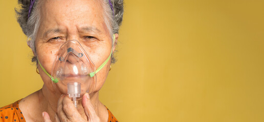 Close-up of a senior woman wearing oxygen mask inhalation undergoing treatment in the hospital....