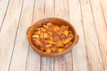 Clay pot of callos a la madrileña with chorizo to serve as a tapa of Spanish tapas restaurant
