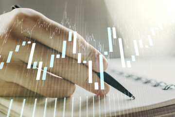 Multi exposure of abstract financial diagram with hand writing in notepad on background, banking...