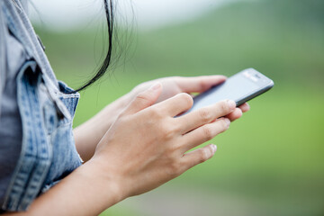 Close Up shot of a woman typing on mobile phone,woman typing text message on smart phone.