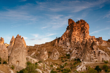 Fototapeta premium Amazing view of Uchisar Castle at suset. The high castle mountain, which is visible over a wide distance. Goreme National Park. Cappadocia.Turkey. Traveling concept background.