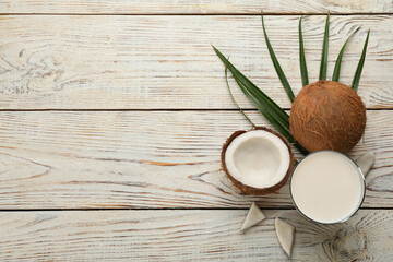 Fototapeta na wymiar Delicious vegan milk and coconuts on white wooden table, flat lay. Space for text