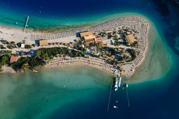 Amazing aerial view of Blue Lagoon in beach resort in the Fethiye district - Oludeniz.  Turkey. Summer landscape with mountains, green forest, turquoise coast in bright sunny day. Travel background.