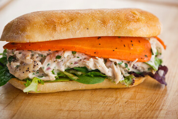 Chicken sandwiches. Served on toasted whole grain bread with melted Swiss cheese, mayonnaise and seasoned salt and pepper.  Classic American restaurant or diner lunch or brunch sandwich favorite.