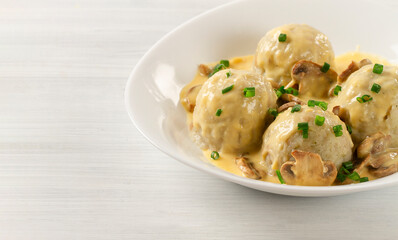 Bavarian bread dish, Semmelknudel, with mushrooms, in cream sauce, horizontal, no people,