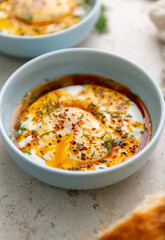 Turkish Eggs Dish Cilbır in Small Blue Bowl