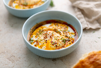 Turkish Eggs Dish Cilbır in Small Blue Bowl