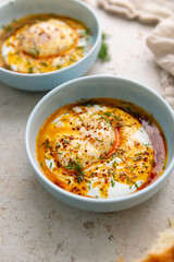 Turkish Eggs Dish Cilbır in Small Blue Bowl
