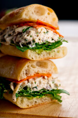 Chicken sandwiches. Served on toasted whole grain bread with melted Swiss cheese, mayonnaise and seasoned salt and pepper.  Classic American restaurant or diner lunch or brunch sandwich favorite.