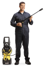 Full length portrait of a worker with a pressure washer machine