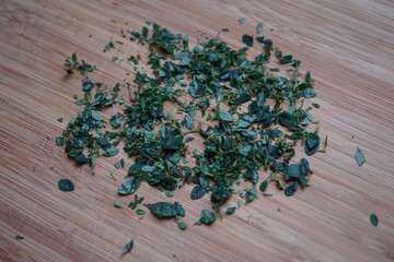 minced chopped lemon thyme on wooden board