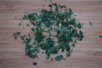 minced chopped lemon thyme on wooden board