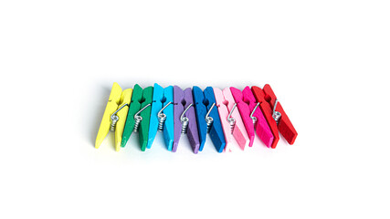 Wooden colorful clothespins isolated on a white background.