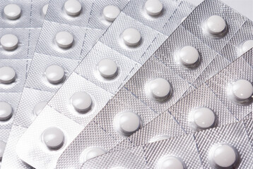 White round pills in a metallic blister