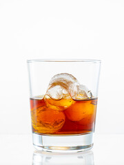 splash from falling ice glass with whiskey on white background