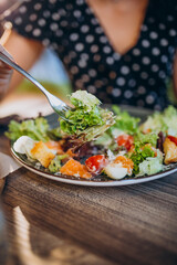 Young woman eating salad in a cafe