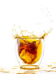 splash from falling ice in a glass with double walls