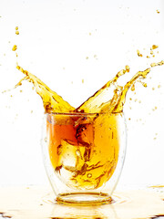 splash from falling ice in a glass with double walls