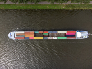 Container cargo ship at Amsterdams Rijn Canal in the Netherlands, topdown birdsseye view