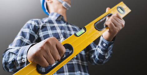 A male engineer is working and using a water level meter.
