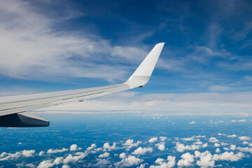 Plain wing over blue sky. Flight from Helsinki to Amsterdam.