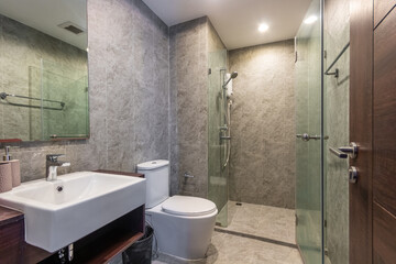 Clean and black bathroom with amenities in house, Decorated with bare cement