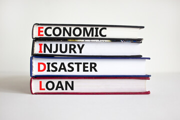 EIDL symbol. Abbreviation EIDL economic injury disaster loan on books. Beautiful white background....