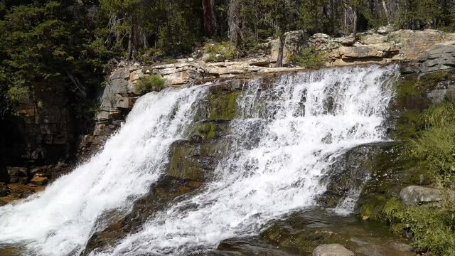 Slow motion shot of the beautiful Provo Falls waterfall in the Uinta Wasatch Cache National Forest in Utah on a bright sunny summer day.