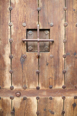 Old, aged, traditonal wooden carved doors in Seville