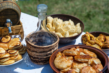 Lot of pancakes, dumplings and wine on the table, Ukraine. Traditional ukrainian food