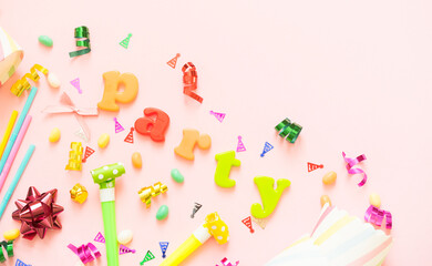Composition of party accessories on a pink background