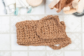 natural bathroom accessories. bath sponges, washcloths, soap and towels on a light background. hygiene cleanliness concept