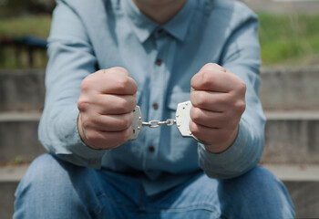 Businessman in handcuffs, criminal concept.