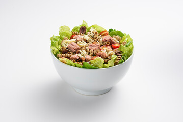 Fresh tuna, pasta and ricotta cheese salad, in white bowl, isolated