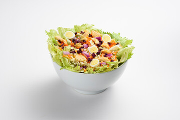 Fresh colorful quail egg, shredded carrots and beets salad, in white bowl, isolated