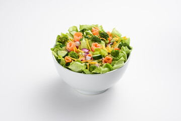 Fresh salmon, cucumber and broccoli salad, in white bowl, isolated