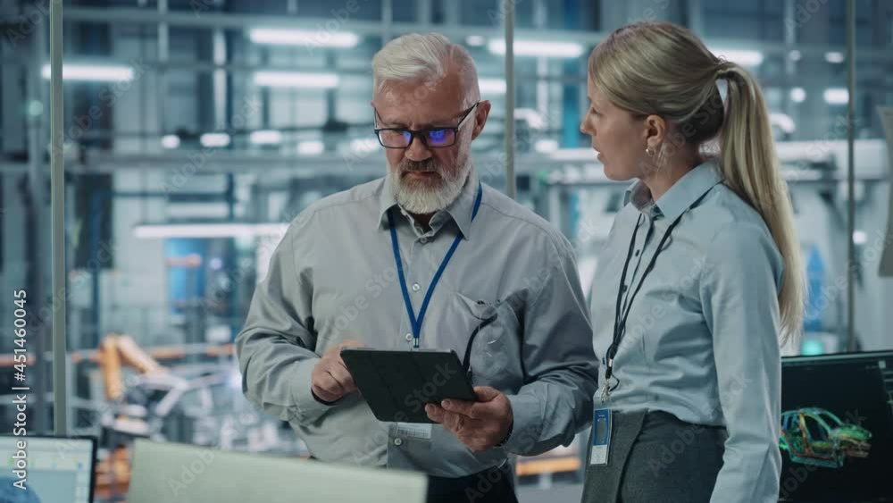 Aufkleber car factory: female project manager talks to male automotive engineer, plan strategy using tablet co