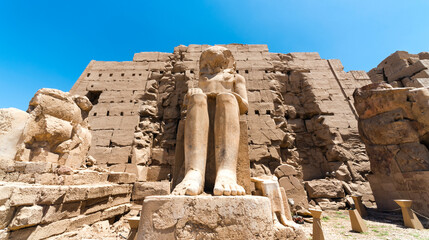 Feet of an ancient statue of Pharaoh in the Karnak temple in Luxor