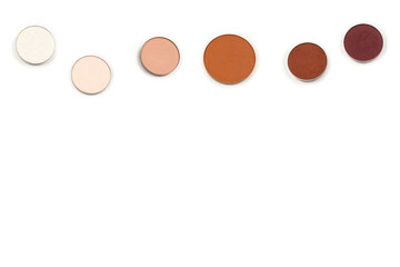 Round multicolored make up eyeshadows isolated on white.