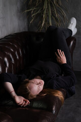 portrait of confident woman in black in dark room. pensive serious people. business woman. feminine. millennial people