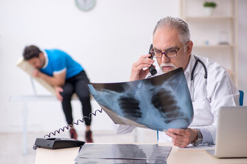 Young male patient visiting old male doctor radiologist