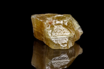 Macro mineral stone yellow Calcite on a black background