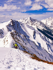 Person Hiking In Winter In Epic Snow Peak Mountain Landscape